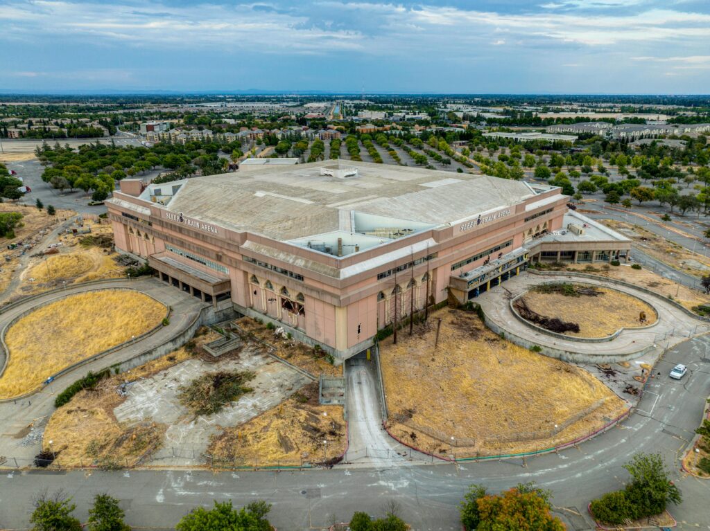 Aerial shot of the historic Sleep Train Arena and surrounding landscape in Sacramento, California.